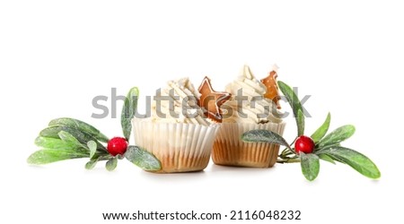 Delicious Christmas cupcakes and decor on white background