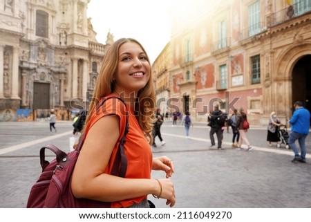 Beautiful excited school exchange girl visiting Europe within the exchange program Royalty-Free Stock Photo #2116049270