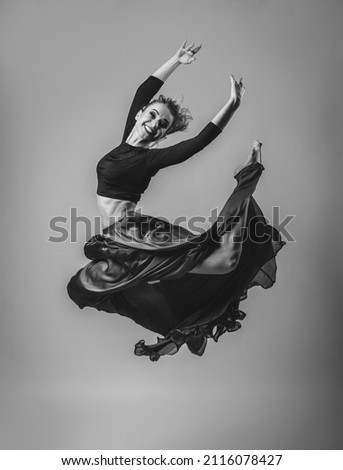 Woman Dancing with Silk Fabric dress, Modern Dancer in Fluttering Waving Cloth on Gray Background