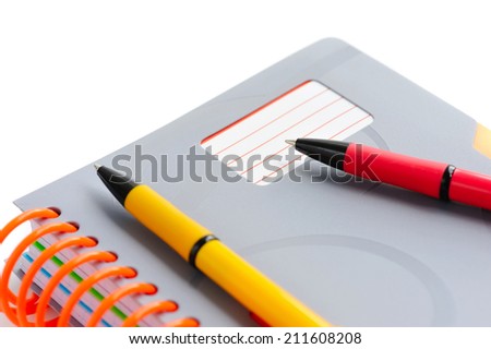 Notebook and pens isolated on white background