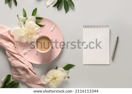Empty blank for planning with morning coffee cup, white peonies on light background. Guest List. Wedding invitation. View from above, copy space. Royalty-Free Stock Photo #2116113344