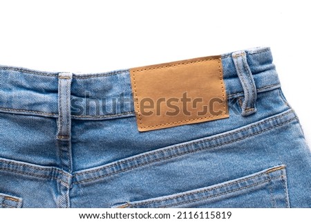 Label mockup on blue denim from recycled paper on a white background.