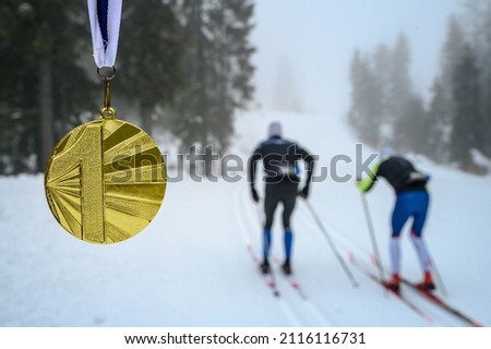 Gold medal, sport trophy, white winter nature in background. Original Wallpaper for winter game in China