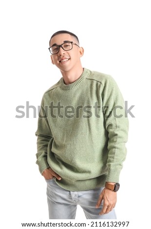 Handsome Asian man in knitted sweater on white background