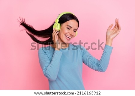 Photo of cute adorable lady dressed blue shirt dancing listening songs earphones isolated pink color background