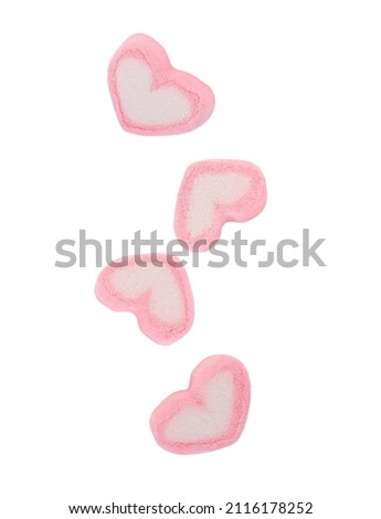 Sweet heart shape of marshmallow falling in the air isolated on white background.