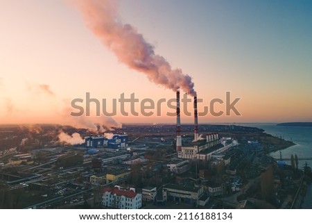 Air pollution by smoke of the factory smokestack in the industrial zone. Industrial plant pipe and Global warming concept Royalty-Free Stock Photo #2116188134