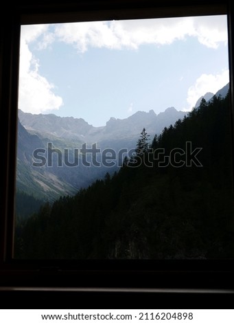 View through a hut window on the Alps near Gramais during summer