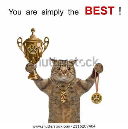 A beige cat holds a gold cup and a medal. You are simply the best. White background. Isolated.