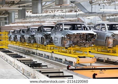 Photo of automobile production line. Modern car assembly plant. Modern and high-tech automotive industry. Conveyor of auto bodies Royalty-Free Stock Photo #2116220060