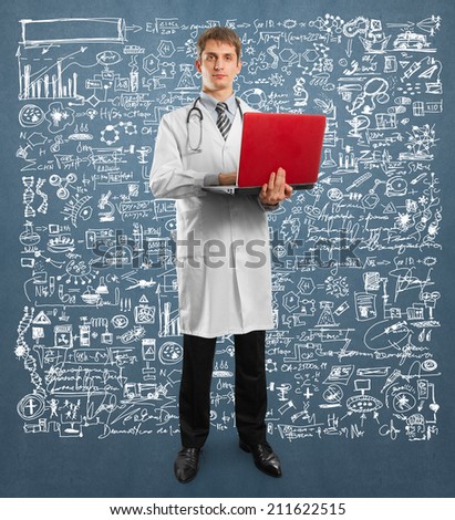 male doctor in suit with laptop in his hands, looking on camera