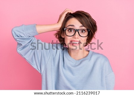 Portrait of attractive unsure girly awkward girl dont know reaction oops isolated over pink pastel color background