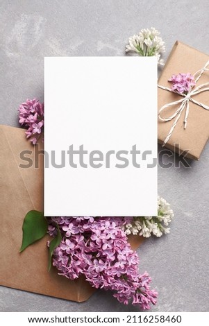 Greeting or invitation card mockup with gift box, envelope and spring lilac flowers Royalty-Free Stock Photo #2116258460