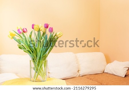 Light minimal living room with spring bouquet of tulips. 8 March, birthday, Valentine day concept.