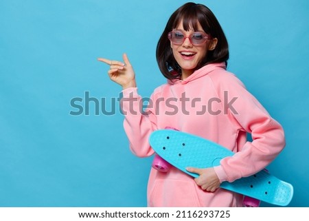 beautiful woman in a pink sweater skateboard entertainment isolated background