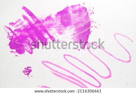 Wavy line and a smear of pink lipstick, smeared on a white background, beauty concept.