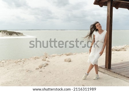 The sublimity of sand, lake, and woman's beauty