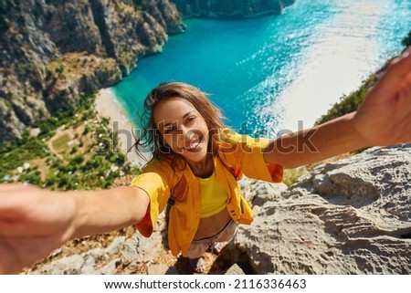 Beautiful woman making selfie outdoors sharing travel adventure, taking picture for social media, enjoying Turkish vacation