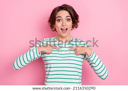 Portrait of attractive amazed cheerful brunette girl pointing at herself isolated over pink pastel color background