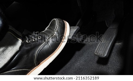 Accelerate and Brake. Foot pressing foot pedal of a car to drive ahead. Accelerator and brake pedal in a car. Driver driving the car by pushing accelerator pedals of the car. inside vehicle automobile Royalty-Free Stock Photo #2116352189