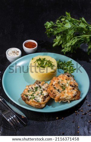 chicken with mushrooms, cheese and mash black background, foreground