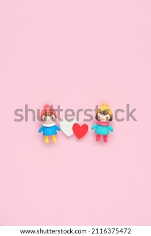 two toy dolls with red and white hearts on pink background. cute toy friends with hearts. 14 february, Valentine's day, Love, romance, friendship concept. flat lay. copy space	