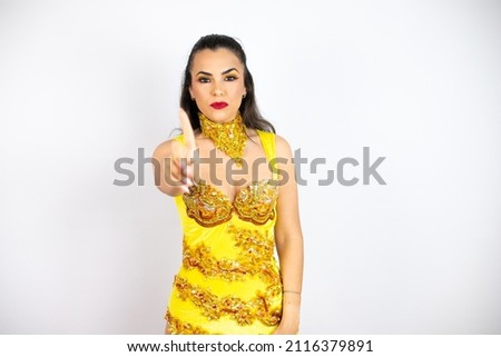 Young beautiful woman wearing carnival costume over isolated white background showing and pointing up with fingers number one while is serious