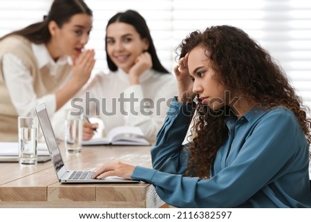 African American woman suffering from racial discrimination at work Royalty-Free Stock Photo #2116382597