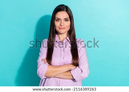 Photo of self-assured positive lady crossed hands wear purple shirt isolated turquoise color background