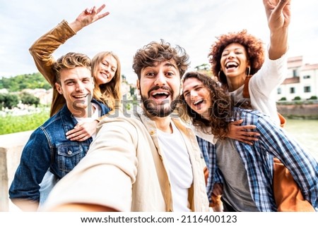 Multiracial friends taking selfie pic outside - Group of young people celebrating together looking at camera - Guys and girls having fun hanging out on sunny day - Friendship and happy lifestyle