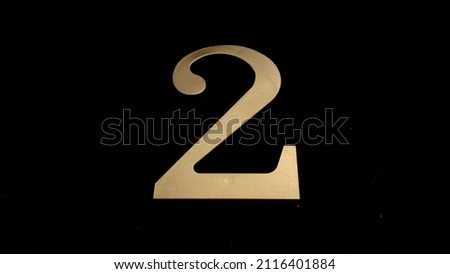 Gold numbers on a black background symbolize a date or designate something