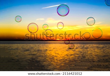 Soap bubbles on the background of dawn. Sunrise soap bubbles. Soap bubbles at sunrise. Soap bubbles at dawn background Royalty-Free Stock Photo #2116421012