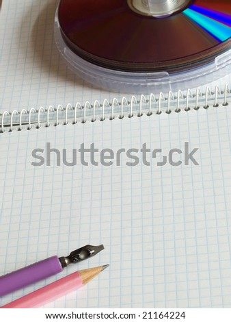 school supplies on squared sheet of a copybook