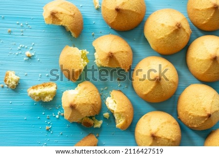 Shortbread cookies consisting of butter, flour, and jam filling, close-up view of a baked sweet cookie on a wooden background, top view