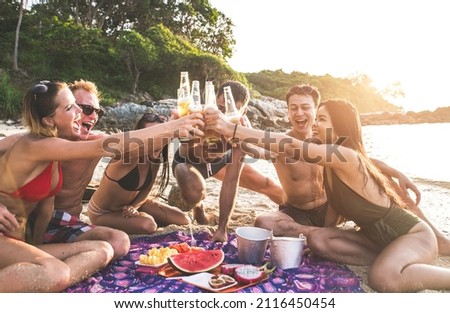 Group of friends having fun on the beach on a lonely island Royalty-Free Stock Photo #2116450454