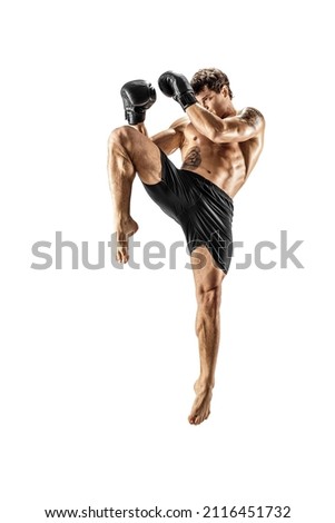 MMA. Full length of professional male kickboxer boxing isolated on white studio background. Fit muscular caucasian athlete fighting. Sport, competition, excitement and human emotions concept.  Royalty-Free Stock Photo #2116451732