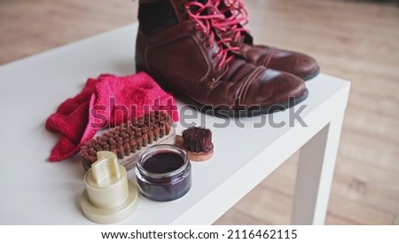 Dirty Worn Out Brown Leather Winter Boots Prepared for Waxing Waterproofing and Polishing With Shoe Care Accessories Royalty-Free Stock Photo #2116462115