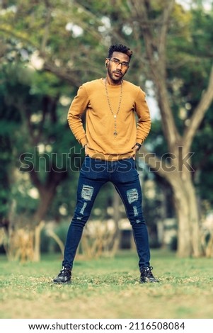 portrait of a man looking defiantly at the camera with his hands on his hips Royalty-Free Stock Photo #2116508084