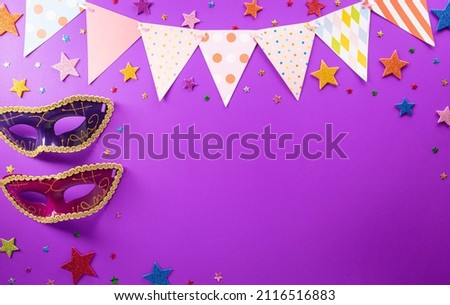 Happy Purim carnival decoration concept made from mask and sparkle star on purple background. (Happy Purim in Hebrew, jewish holiday celebrate)