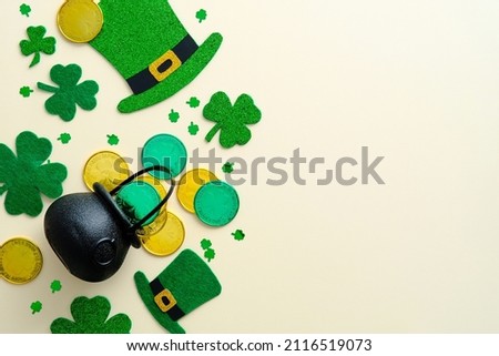 Happy St. Patrick's Day banner design. Flat lay composition with shamrock, pot of gold coins , leprechaun hats on vintage background.
