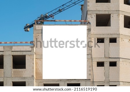 Advertising billboard mock-up mounted on the wall of building under construction