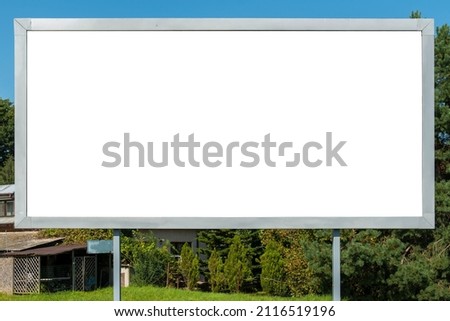 Advertising billboard mock-up in front of the house on a sunny summer day