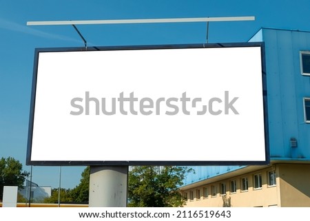 Advertising billboard mock-up in front of the office building on a sunny day