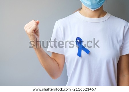 March Colorectal Cancer Awareness month,  dark Blue Ribbon for supporting people living and illness. Healthcare, hope and World cancer day concept Royalty-Free Stock Photo #2116521467