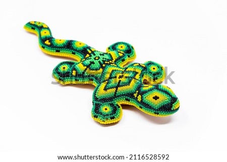 Beautiful huichol tradition pattern crafted lizard isolated