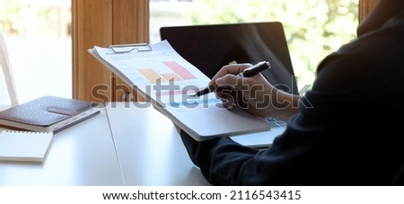 Businessman investment consultant analyzing company annual financial report balance sheet statement working with documents graphs. Concept picture of business, market, office, tax.
