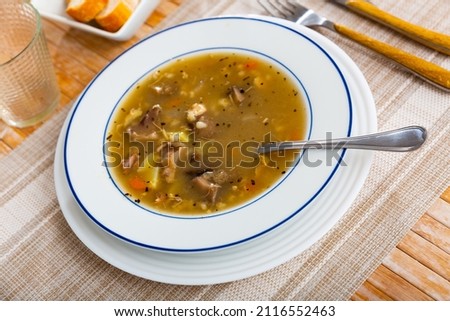 Delicious thick rustic style mushroom soup cooked in meat stock with pork and vegetables..