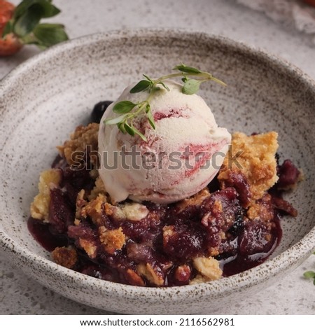 all berries crumble from strawberry, blueberry and mulberry topped with crumble made from butter, almond flour and coconut flour. sweet and tangy taste perfect for summer dessert. Royalty-Free Stock Photo #2116562981
