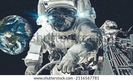 Astronaut spaceman do spacewalk while working for spaceflight mission at space station . Astronaut wear full spacesuit for operation . Elements of this image furnished by NASA space astronaut photos .
