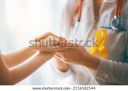 World Childhood cancer Day. Girl patient listening to a doctor in medical office. Royalty-Free Stock Photo #2116582544